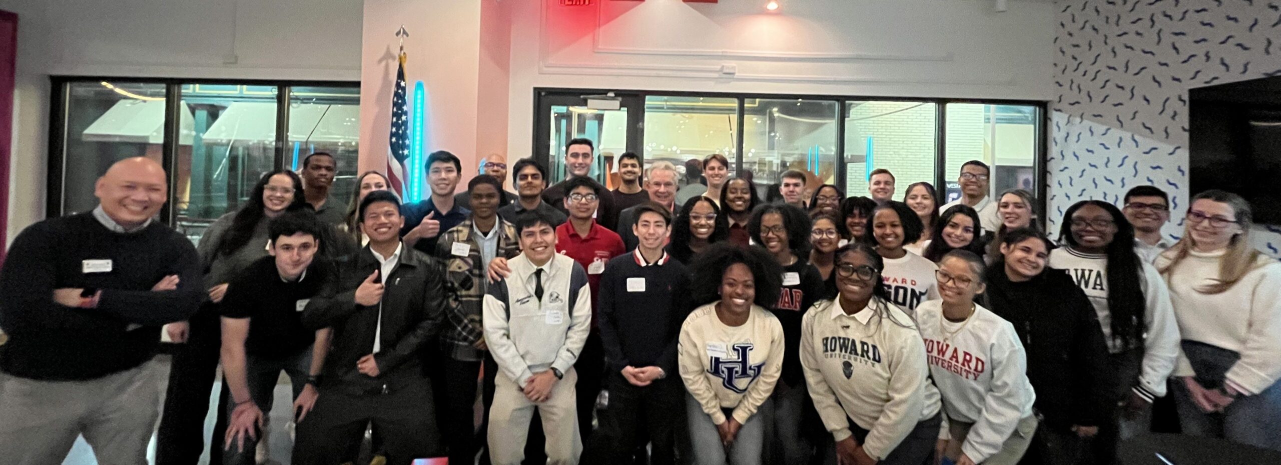 Large group of cadets smiling and posing together indoors at a financial readiness workshop event.